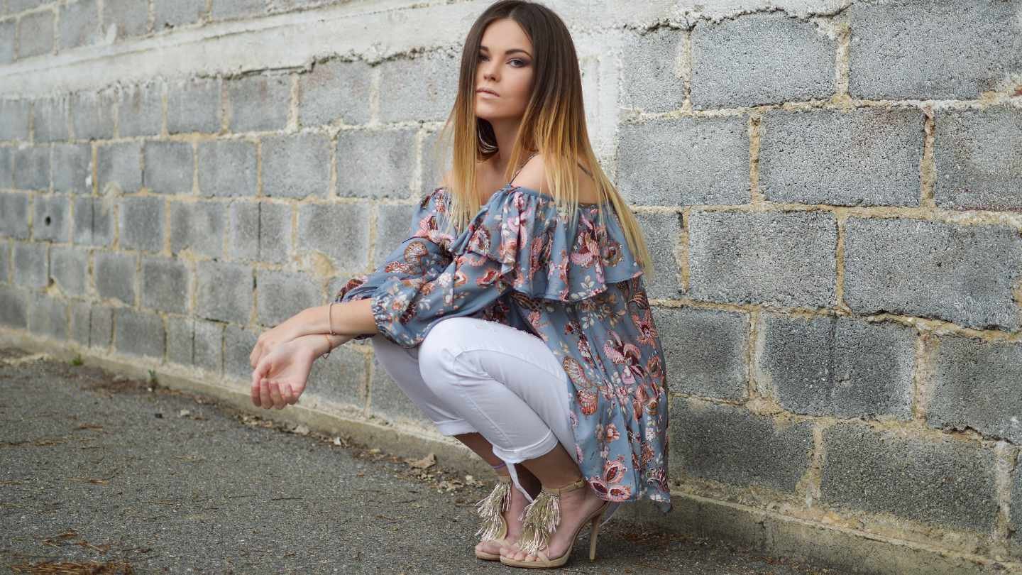 Woman Crouching with Patterned Top