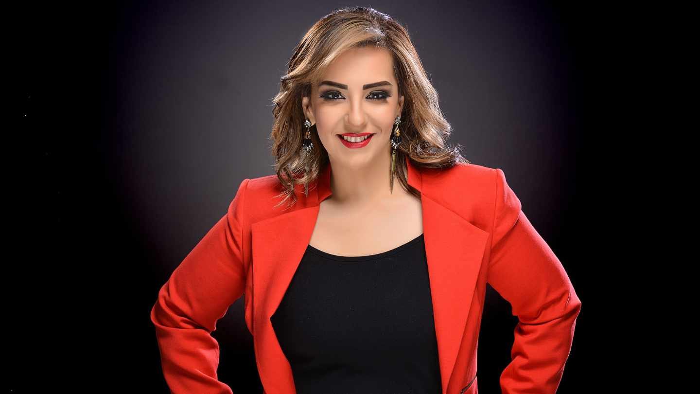 Woman in Power Pose with Red Jacket